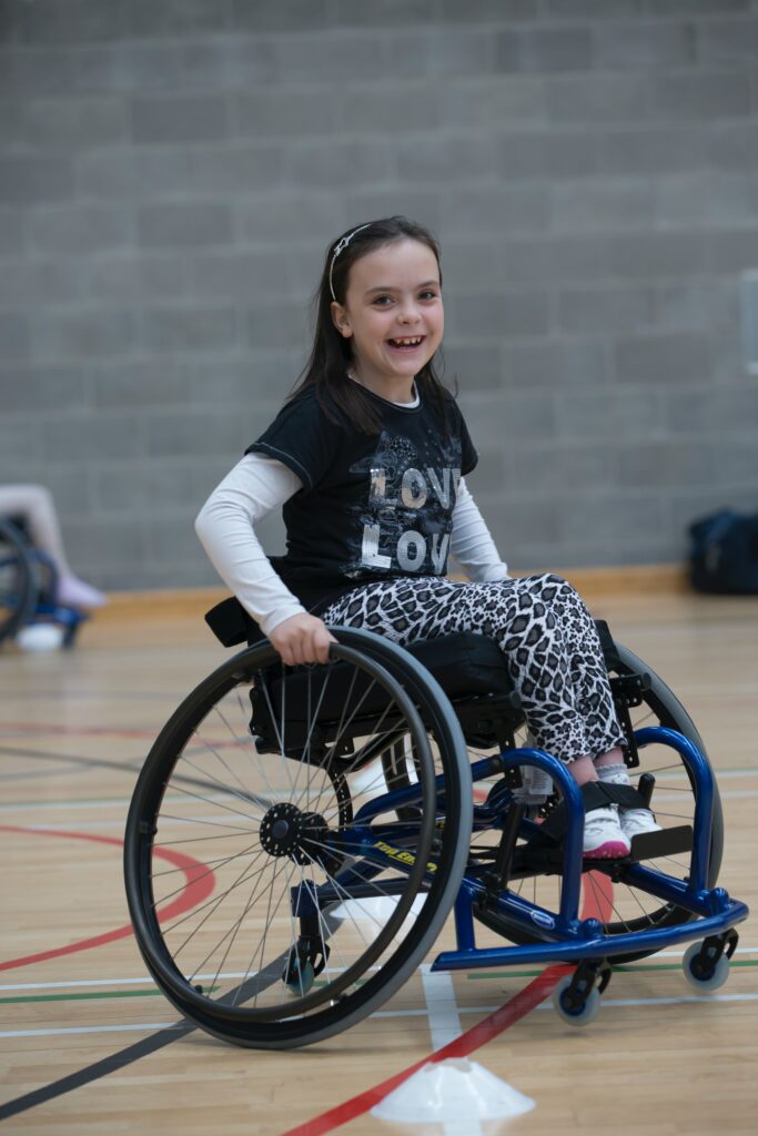 smiling child in a wheelchair